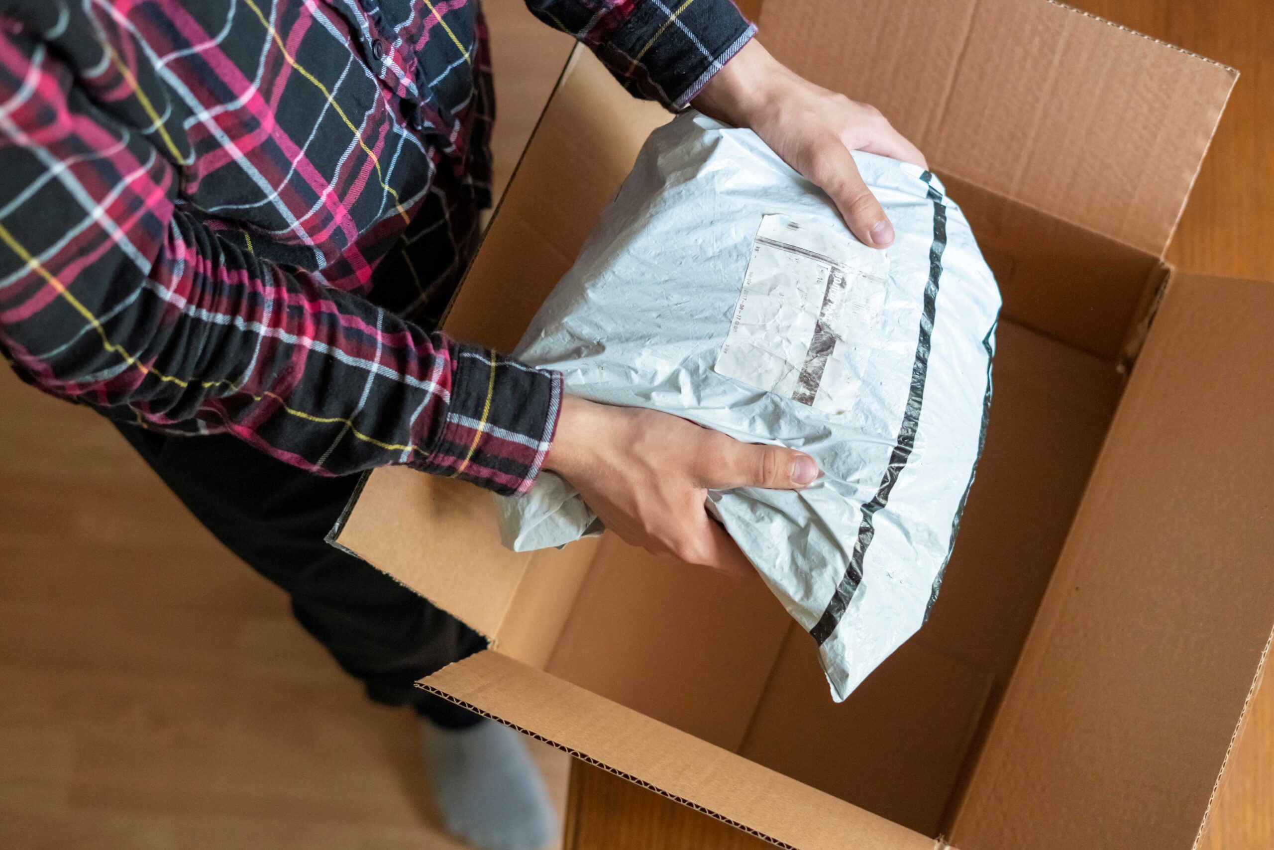 A man unpacking a home delivery box.